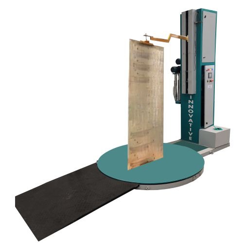 Automatic horizontal orbital door wrapping machine wrapping a stack of wooden doors at Innovative Wraptech Pvt. Ltd.